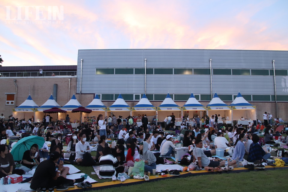 ▲ 참여자들이 잔디에 돗자리를 깔고 앉아 먹고 마시며 페스티벌을 즐기고 있다. ⓒ라이프인