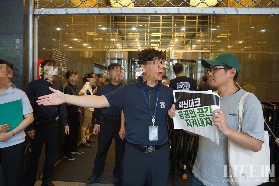 ▲ 서울시 공무원이 '서울창조타운 조성 기업설명회'를 앞두고 '서울네트워크' 소속 시민활동가의 시청 출입을 제한하고 있다. ⓒ라이프인 